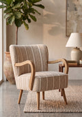 A mid-century modern accent chair with curved wooden arms and legs, upholstered in a beige and white striped fabric, shown on a gray tiled floor.